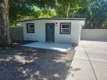 Charming home featuring a front door, windows, and a newly-laid patio, perfect for welcoming guests at 825 Lincoln Ave, Tarpon Springs, FL 34689