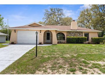 Charming single-story home with well-maintained landscaping, stone accents, and a two-car garage at 8466 Eldridge Rd, Spring Hill, FL 34608