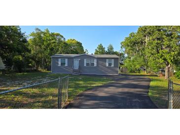 Charming single-story home features a well-maintained yard, driveway, and appealing exterior paint at 9625 Pat St, Hudson, FL 34669
