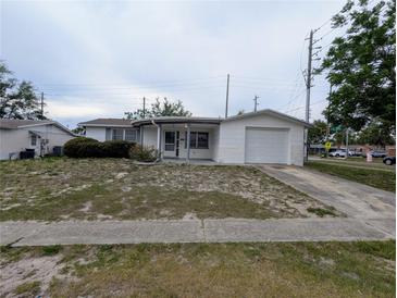 Charming single-story home with attached garage and a covered front porch at 5949 1St Ave, New Port Richey, FL 34652