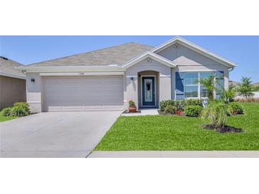 Charming single-story home with a two-car garage and well-manicured lawn at 13160 Golden Lime Ave, Spring Hill, FL 34609
