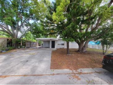 Charming single-story home with mature trees and covered parking, creating a welcoming curb appeal at 4118 Flamingo Dr, New Port Richey, FL 34652