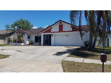 Charming single-story home with a well-maintained lawn, driveway, and a two-car garage at 2538 Indigo Dr, Dunedin, FL 34698