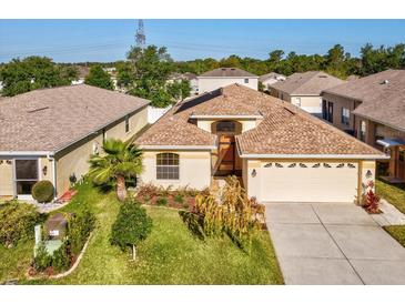 Lovely single-story home with a well-manicured lawn and mature landscaping at 4321 High Ridge Ave, Spring Hill, FL 34609