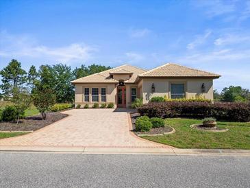 Charming home with brick driveway, landscaped garden, and inviting entryway offers great curb appeal at 9159 Trevino Dr, Weeki Wachee, FL 34613