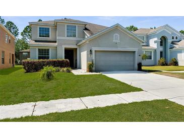 Charming two-story home featuring a well-maintained lawn and a two-car garage at 951 Nodding Shade Dr, Brooksville, FL 34604