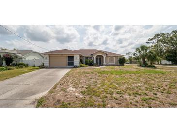 Charming single-story home with a two-car garage and manicured lawn at 1034 Aladdin Rd, Spring Hill, FL 34609