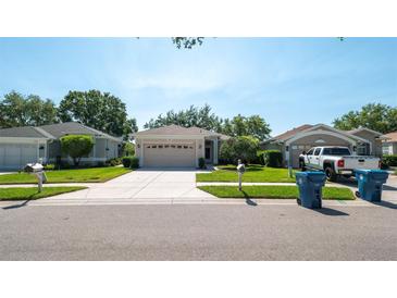 Charming single-story home with well-manicured lawn and inviting curb appeal in a quiet neighborhood at 15038 Tamarind Loop, Spring Hill, FL 34609