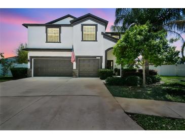 Beautiful two-story home with a well-manicured lawn, a three-car garage, and an inviting facade at 3555 Bracknell Ct, Land O Lakes, FL 34638