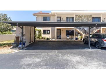 View of a carport with parking and storage for a multi-Gathering home, providing covered parking at 9970 Eagles Point Cir # 3, Port Richey, FL 34668