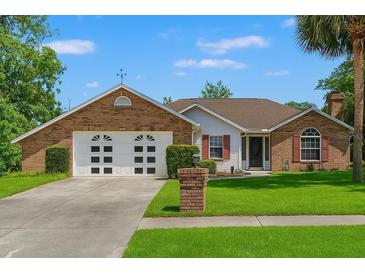 Charming brick home with two-car garage and well-manicured lawn in a suburban setting at 13469 Pia Ct, Spring Hill, FL 34609