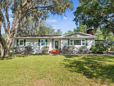 Charming single-story home with well-manicured lawn and mature trees offering shade at 196 Lark Ave, Brooksville, FL 34601