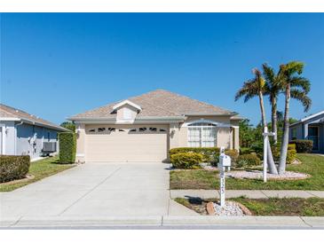 Charming single-story home featuring a well-manicured lawn, two-car garage and inviting curb appeal at 2325 Pleasant Hill Ln, Holiday, FL 34691