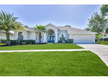 Charming single-story home with well-manicured lawn and lush landscaping at 4044 Chesterfield Dr, Spring Hill, FL 34609