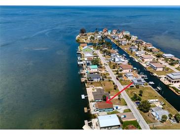 Aerial view of waterfront homes along a narrow canal in a coastal community at 6622 Seaview Blvd, Hudson, FL 34667
