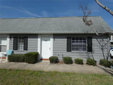 Charming single-story home featuring gray siding, black shutters, and well-maintained landscaping at 6636 Timbercove Ln # 6636, New Port Richey, FL 34653