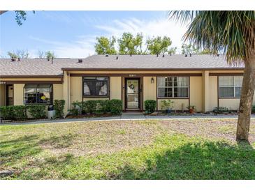 Inviting single-story villa showcasing a well-manicured lawn and quaint front entrance at 11241 Dollar Lake Dr # 5, Port Richey, FL 34668