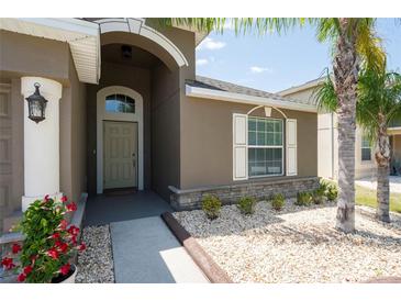 Charming home featuring well-manicured landscaping, a welcoming entrance, and stone accents for added curb appeal at 18353 Briar Oaks Dr, Hudson, FL 34667