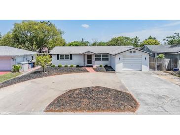 Charming single-story home featuring well-maintained landscaping and a classic brick facade at 6611 Ridge Crest Dr, Port Richey, FL 34668