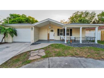 Charming single-story home with a well-manicured lawn and a welcoming front porch at 7235 Astor Dr, New Port Richey, FL 34652