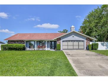 Charming single-story home with well-maintained landscaping and a two-car garage at 12191 Monarco Ln, Spring Hill, FL 34609