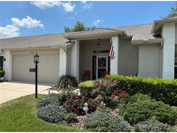 Charming single-story home featuring a landscaped front yard and covered entryway at 18027 Baywood Forest Dr, Hudson, FL 34667