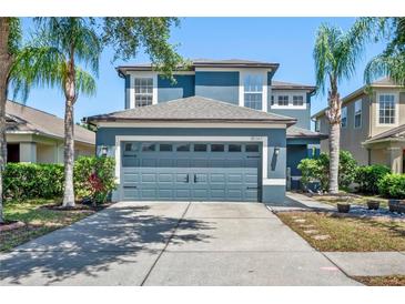 Charming two-story home with a well-maintained lawn and a spacious two-car garage with lush landscaping at 18061 Glastonbury Ln, Land O Lakes, FL 34638