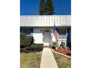 Charming single-story home featuring a well-maintained front yard, white siding, and blue shutters at 4264 Tamargo Dr # 3, New Port Richey, FL 34652