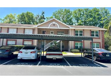 Inviting condo building with covered parking, neat landscaping, and a classic architectural design at 6410 Spring Flower Dr # 26, New Port Richey, FL 34653