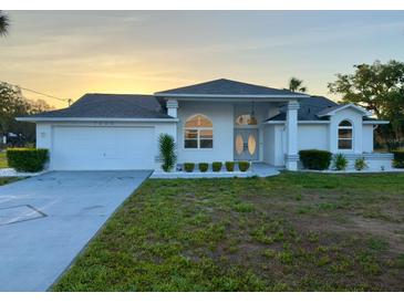 Charming single-story home featuring a two-car garage and well-manicured landscaping at 7538 Landmark Dr, Spring Hill, FL 34606