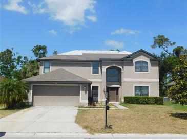 Charming two-story home with a large front yard, attached garage, and a classic mailbox adding to its curb appeal at 9007 49Th E Ave, Palmetto, FL 34221