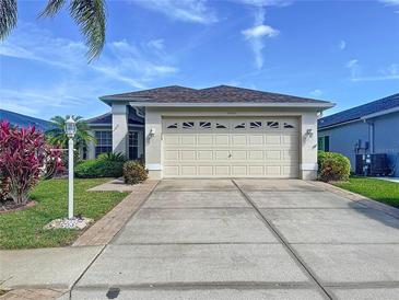 Charming single-story home with a well-manicured lawn, a large two-car garage, and a neutral color scheme at 1006 Sweet Jasmine Dr, Trinity, FL 34655