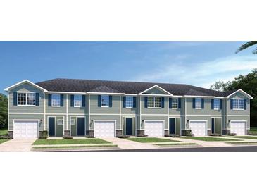 New townhouse with white trim, blue shutters, and single car garage at 20334 Lou Angela Ln, Lutz, FL 33558