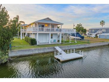 Waterfront home featuring a private dock, elevated deck, and boat parking, perfect for the avid boater at 3340 Oleander Dr, Hernando Beach, FL 34607