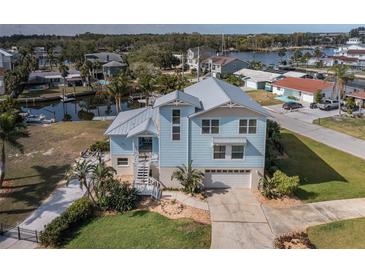 Charming waterfront home with metal roof, manicured lawn, and private canal access at 5040 Waterside Dr, Port Richey, FL 34668