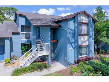 Inviting condo with a blue exterior and a well-manicured lawn at 7662 St Andrews Blvd, Weeki Wachee, FL 34613