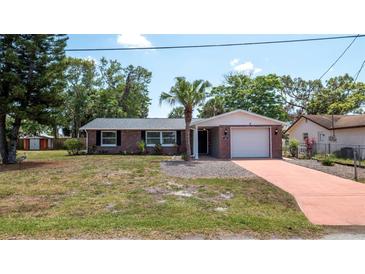 Charming brick home with a well-maintained lawn and inviting curb appeal at 8522 Inwood Dr, Hudson, FL 34667