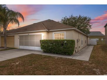 Charming single Gathering home with a well maintained lawn and an attached two car garage at 9048 Southern Charm Cir, Brooksville, FL 34613