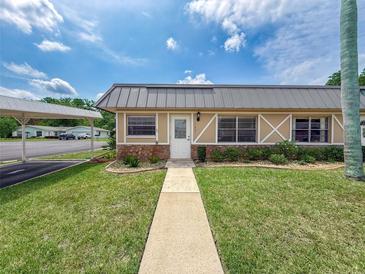 Charming single story home boasts stone accents and a metal roof for lasting beauty at 11601 Bayonet Ln # 163A2, New Port Richey, FL 34654