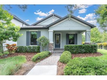 Charming single-story home with tidy landscaping, stone accents and a covered front porch at 3056 Abrams Trl, Odessa, FL 33556