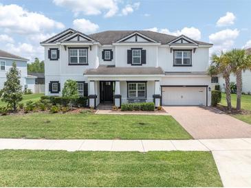 Beautiful two-story home featuring a manicured lawn and a two-car garage at 4188 Barbour Trl, Odessa, FL 33556