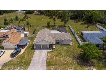 Aerial view of the property with a large, green lawn at 8126 Wooden Dr, Spring Hill, FL 34606