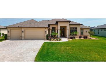 Beautifully landscaped yard with a circular driveway and a charming two-story home with neutral exteriors at 9125 Palm Beach Dr, Brooksville, FL 34613