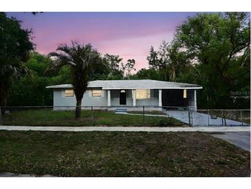 Charming single-story home with a well-maintained lawn, mature trees, and freshly painted exterior at dusk at 18838 Rosephil St, Spring Hill, FL 34610