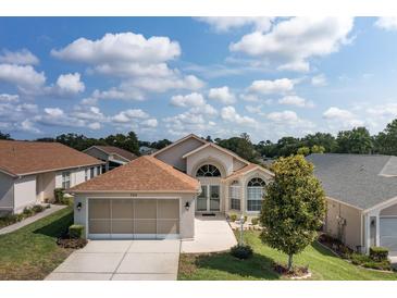 Charming single-story home featuring an attached two-car garage and well-manicured front lawn at 284 Quane Ave, Spring Hill, FL 34609