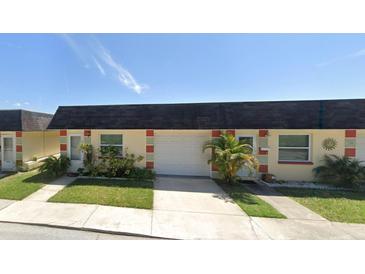 Charming single-story home with a well-maintained lawn, a palm tree, and a one car garage at 5008 Canner St # 4930, New Port Richey, FL 34652