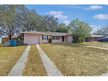 Charming single-story home with a well-maintained lawn and an attached one car garage at 7464 Acorn Cir, Spring Hill, FL 34606