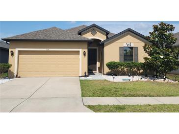 Charming single-story home with well-maintained landscaping, complemented by a two-car garage and neutral exterior at 954 Old Windsor Way, Spring Hill, FL 34609