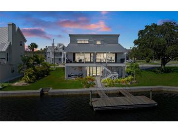 Stunning waterfront home featuring a metal roof, lush landscaping, and a private boat dock at 5234 Foxhall Ct, Weeki Wachee, FL 34607