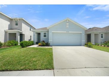 Charming single-Gathering home featuring a well-manicured lawn and a two-car garage in a suburban neighborhood at 33592 Barberry Leaf Way, Wesley Chapel, FL 33543
